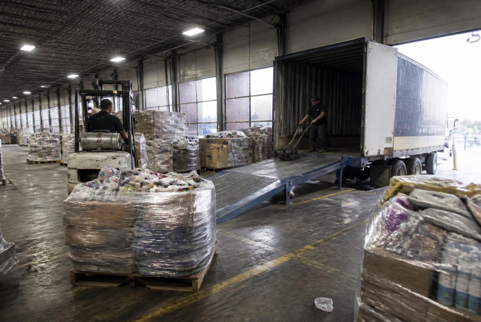 Loading dock stacked with wholesale liquidation pallets of customer returns ready for nationwide shipment